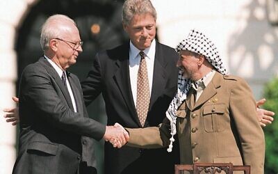 Yitzhak Rabin (left) and Yasser Arafat (right) shake hands at the White House on September 13, 1993, as US president Bill Clinton looks on. Photo: J. David Ake/AFP/Getty Images