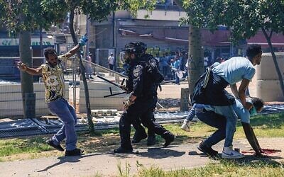 Eritrean protesters clash with Israeli riot police in Tel Aviv. 
Photo: AP Photo/Ohad Zwigenberg