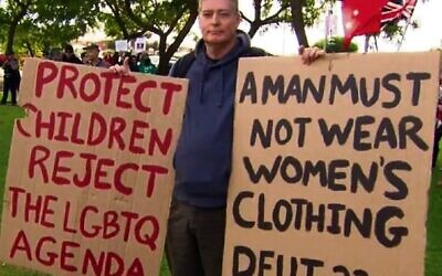Stephen Wells with anti-LGBTQI+ placards.