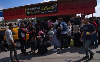 Palestinians at the Rafah border crossing between Gaza and Egypt on October 16, 2023. Photo: Fatima Shbair/AP