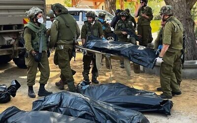 Soldiers prepare bodies in Kfar Aza. Photo: Oren Rosenfeld