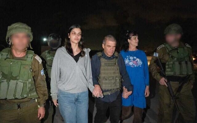 Natalie Raanan, 3rd left, Judith Raanan, right, are seen upon arrival in Israel after being released from Hamas captivity as government hostage envoy Gal Hirsch, center, holds their hands, October 20, 2023 (Courtesy)