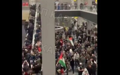 A pro-Palestinian mob storms an airport terminal in Dagestan, Russia, as they look for passengers from a flight arriving from Israel, October 29, 2023. (video screenshot The Times of Israel.)