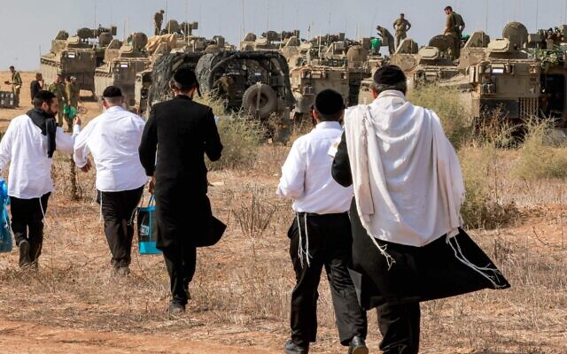Haredi Jews visit Israeli soldiers to show their support as they deploy at a position near the border with Gaza in southern Israel on October 11, 2023. (Menahem Kahana/AFP via Getty Images)