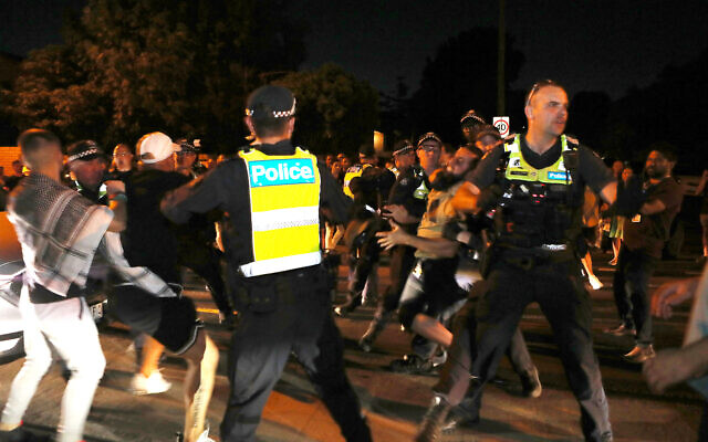 Police apprehend pro-Palestinian protesters who rushed towards pro-Israel supporters at Princes Park on Friday evening. Photo: Peter Haskin.