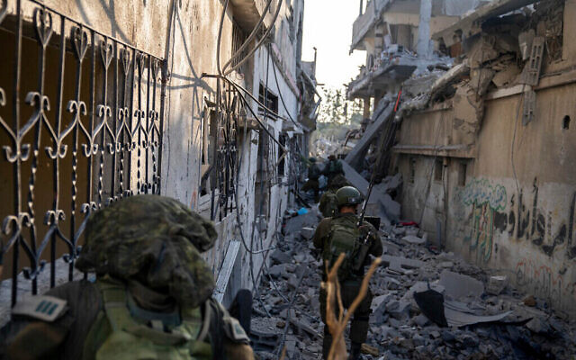 A handout photo provided November 4, 2023, shows Israeli troops operating in the Gaza Strip. (The Times of Israel: Israel Defense Forces vía AP)