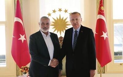 Turkish President Recep Tayyip Erdogan (right) shaking hands with Hamas chief Ismail Haniyeh in February 2020. Photo: Presidential Press Service via AP, Pool/ File