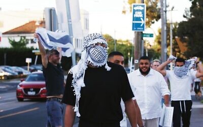 A pro-Israel supporter stands defiant against Pro-Palestinian supporters on Hawthorn Road, Caulfield before the protest on Friday. Photo: Peter Haskin.