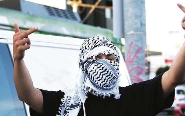 A pro-Palestinian protester in the geographical heart of Melbourne's Jewish community in Caulfield. Photo: Peter Haskin
