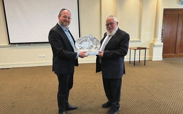 Rabbi Moshe Kahn (left) received a presentation from Rabbi Philip Heilbrunn.