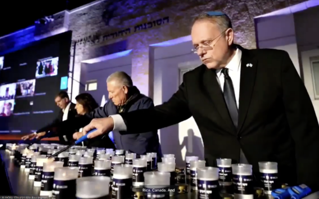 Participants in a ceremony in Jerusalem tied to shloshim, the 30-day mark after a Jewish death, light memorial candles on Sunday, Nov. 5, 2023. (Screenshot)