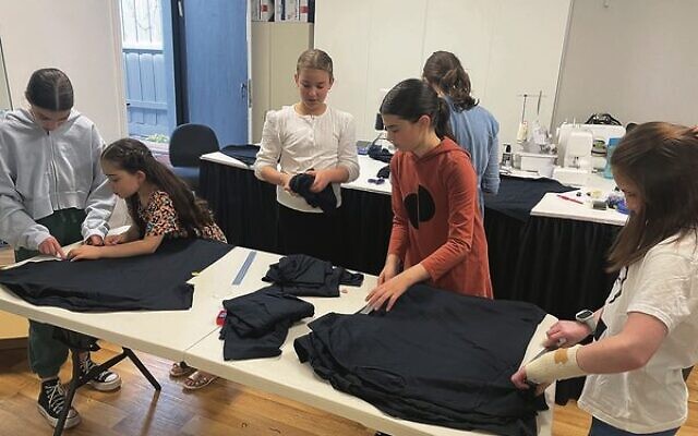 Alana Hersh's sewing students making tzitzit in her workroom.