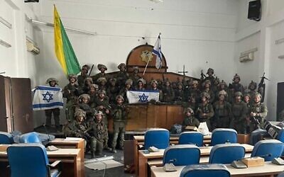 Troops from the IDF's Golani Brigade pose for a photo inside Gaza's parliament building in Gaza City, after capturing the site, on November 13, 2023. (The Times of Israel: Social media; used in accordance with Clause 27a of the Copyright Law)