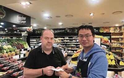 Steven Zhang with UIA CEO Yair Miller, handing over his generous donation. Photo: Supplied