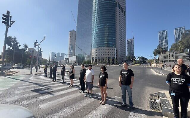 Israelis stand for a minute of silence in Tel Aviv on November 7, 2023, to remember the victims of the October 7 Hamas massacre last month. (The Times of Israel: Photo by Albert Bannon, made available by the Brothers and Sisters in Arms protest group)