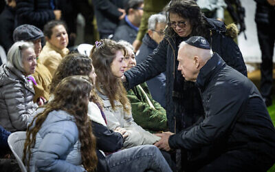 Ashira Grinberg, wife of Lt. Col. Tomer Grinberg, the Commander of the Golani Brigade's 13th Battalion, is comforted by Defense Minister Yoav Galant during his funeral at the Mount Herzl Military Cemetery in Jerusalem on December 13, 2023, Grinberg was killed in battle along with several soldiers in Shejaiya, Gaza Strip. (The Times of Israel: Yonatan Sindel/Flash90)