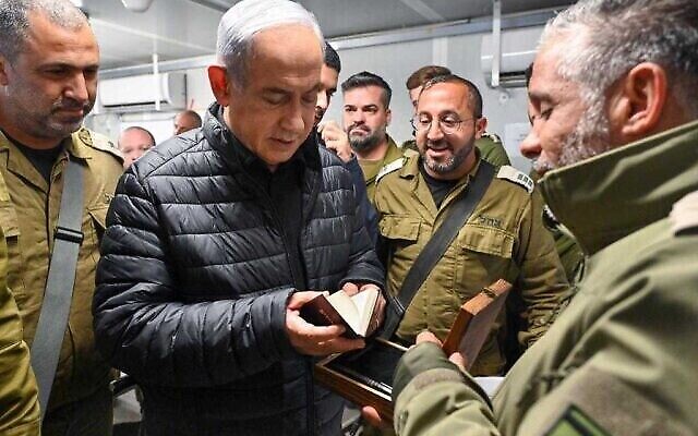 Prime Minister Benjamin Netanyahu visits a detention facility in southern Israel where Hamas operatives detained in the Gaza Strip are being questioned by the IDF's 504 human intelligence unit, December 13, 2023. (The Times of Israel: Kobi Gideon/GPO)