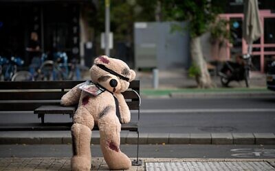 A giant teddy bear dedicated to Emilia Aloni, aged five, with its eyes covered and showing signs of injury sits on a street bench in Tel Aviv to draw attention to the plight of the hostages. Aloni and her mother were released by Hamas, but many of their relatives remain in Gaza. (Keller: via Christopher Furlong/Getty Images)
