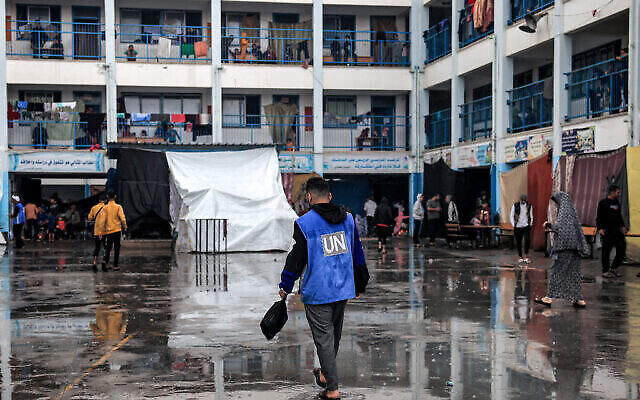 A man walks with a vest bearing the logo of the UN at a school run by UNRWA in Rafah in the southern Gaza Strip on November 14, 2023. (The Times of Israel: Said Khatib/AFP)