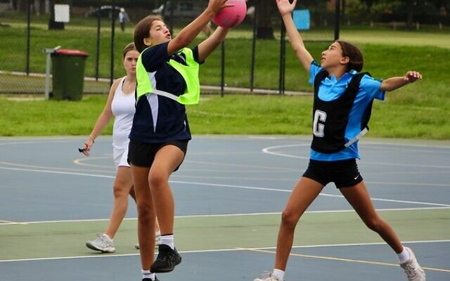 Victoria yellow's Bowie Isaacs (left) and NSW black's Mia Berkovic in the 'Carni' netball competition. Photo: Shane Desiatnik