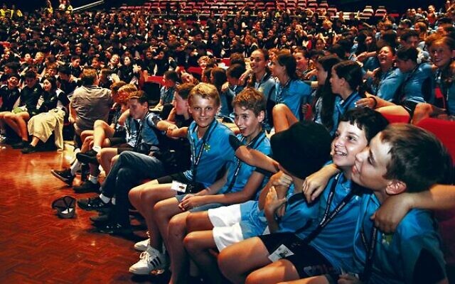 NSW team members (front) and Victorian kids (back) get into the Maccabi Junior Carnival spirit at the opening ceremony. Photos: Shane Desiatnik