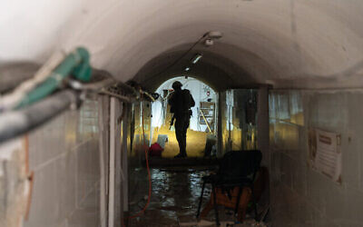 A soldier stands in a Hamas tunnel underneath a UNRWA school in Gaza City, February 8, 2024. (The Times of Israel: Emanuel Fabian/Times of Israel)