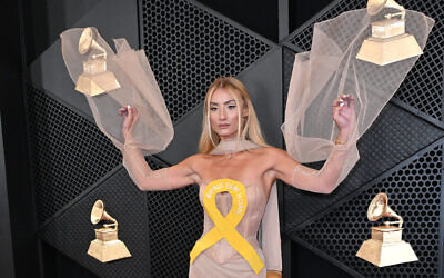 Singer and influencer Montana Tucker arrives for the 66th Annual Grammy Awards at the Crypto.com Arena in Los Angeles on February 4, 2024, wearing a dress with a yellow ribbon meant to call attention to the Israeli hostages in Gaza. (JTA: Photo by Robyn Beck/AFP via Getty Images)