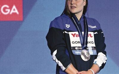 Anastasia Gorbenko wearing her medal on the podium at the World Championships in Doha. 
Photo: Oli Scarff/AFP