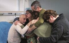 Louis Har (left) and Fernando Marman (second from right) are reunited with loved ones at Sheba Medical Centre, February 12, 2024. Photo: Israel Defence Forces