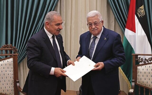 Outgoing PA Prime Minister Mohammad Shtayyeh (left) presents the resignation of his government to President Mahmoud Abbas in Ramallah on February 26, 2024. 
Photo: Thaer GHANEM / PPO / AFP