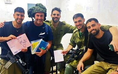Danny Hochberg (second from left) delivers cards from Australian well-wishers to IDF troops in October last year.
