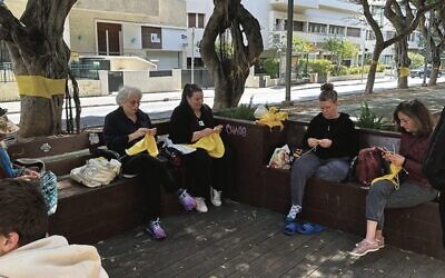 Israeli women in Tel Aviv knitting tree huggers