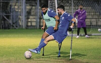 The team's striker, Ben Maman (right), challenges for the ball at training in Ramat Gan on March 28. Photo: Jack Guez/AFP