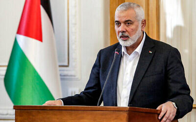 Ismail Haniyeh, the Doha-based political bureau chief of Hamas, speaks to the press after a meeting with the Iranian foreign minister in Tehran on March 26, 2024. (The Times of Israel: AFP)