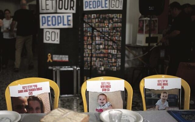 Chairs for the missing Bibas family at a symbolic Seder table at the communal dining hall at Kibbutz Nir Oz on April 11. Photo: Maya Alleruzzo/AP