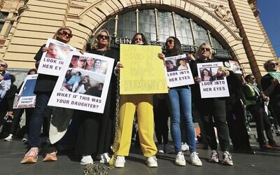 In response to the video released of five female Israeli women being taken hostage on October 7, a rally and human installation was held on Tuesday on the steps of Flinders Street Station in Melbourne. Photo: Peter Haskin