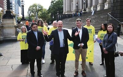 Stop the Hate Mate rally organisers (from left) Rev John Smith, Rabbi Moshe Kahn, Rev Mark Leach and Jasmine Yuen get together on the steps of Victorian Parliament House ahead of the rally this Sunday. Photo: Peter Haskin