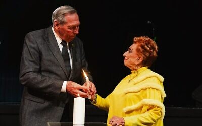 Jan Anger and Lilly Wolf lighting a commemorative candle. Photo: Giselle Haber
