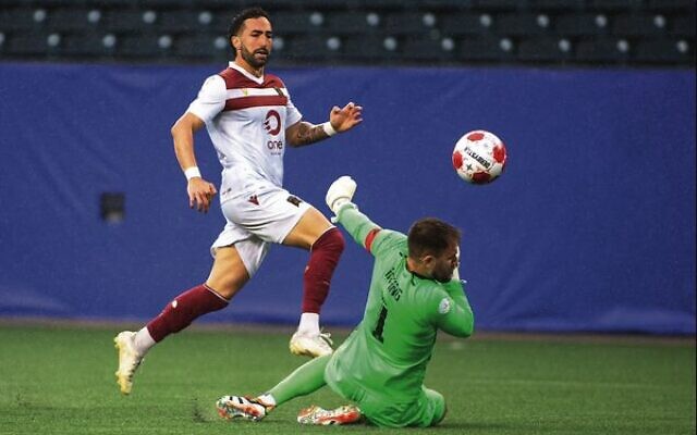 Valour FC's Jordi Swibel chips over Vancouver FC's keeper to score his second goal in the 2-0 win in Winnipeg on June 2. Photo: Cameron Bartlett/CPL
