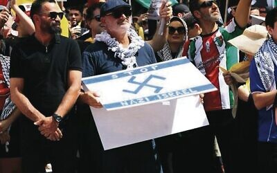 Owner of Nomad Alan Yazbek with his offensive sign.