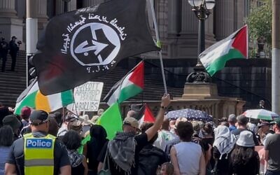 The flag of the banned terrorist organisation the Popular Front for the Liberation of Palestine being openly flown outside Victoria’s state parliament as Police look on.