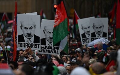 Images of Benjamin Netanyahu with a Hitler moustache at the "March for Humanity" on Sunday. Photo: AAP Image/Dean Lewins
