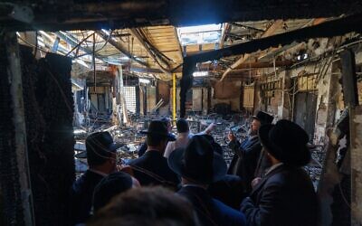 Australia's Prime Minister Anthony Albanese (C) and members of the local Jewish community visiting the torched Adass Israel Synagogue in Melbourne on December 10, 2024. (DEPARTMENT OF PRIME MINISTER AND CABINET / AFP)