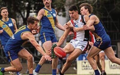 Jackas youngster Jonty Israel kicks in heavy traffic in the men's Premier C decider last Sunday. Photos: Yaakov Frenkel