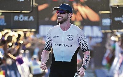Yisroel Rosenbaum pumps his fist after crossing the finish line at the 2025 Ironman World Championships in Nice, France. Inset: A logo on his jersey.