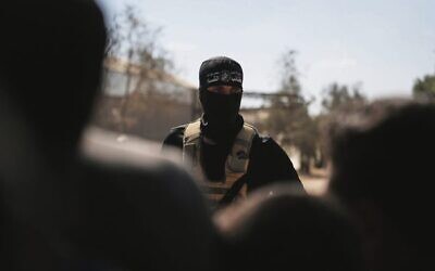 A masked Hamas gunman in Khan Younis ahead of handing over Israeli hostages to the Red Cross on October 13.Photo: AP Photo/Abdel Kareem Hana