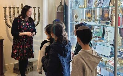 Sassoon Yehuda Sephardi Synagogue president Joanne Levy with students exploring the Sephardi Heritage Museum of Australia.