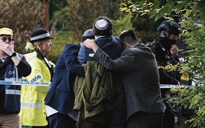 Members of the Jewish community comfort each other near the Heaton Park Synagogue in Manchester on October 2. Photo: Peter Byrne/PA via AP/TOI Members of the Jewish community comfort each other near the Heaton Park Synagogue in Manchester on October 2. Photo: Peter Byrne/PA via AP/TOI