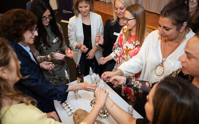 Members of the Melbourne Chapter of the Entrepeneurs Organisation see the shabbat candles lit. Photo: Dean Cherny.