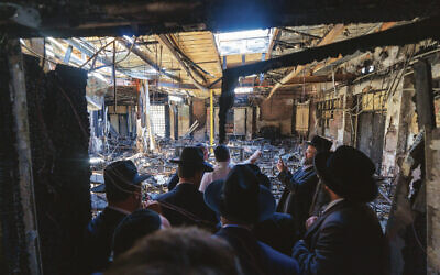 Prime Minister Anthony Albanese surveys the damage to the firebombed Adass Israel synagogue with members of the community.  Photo: Prime Minister’s Department